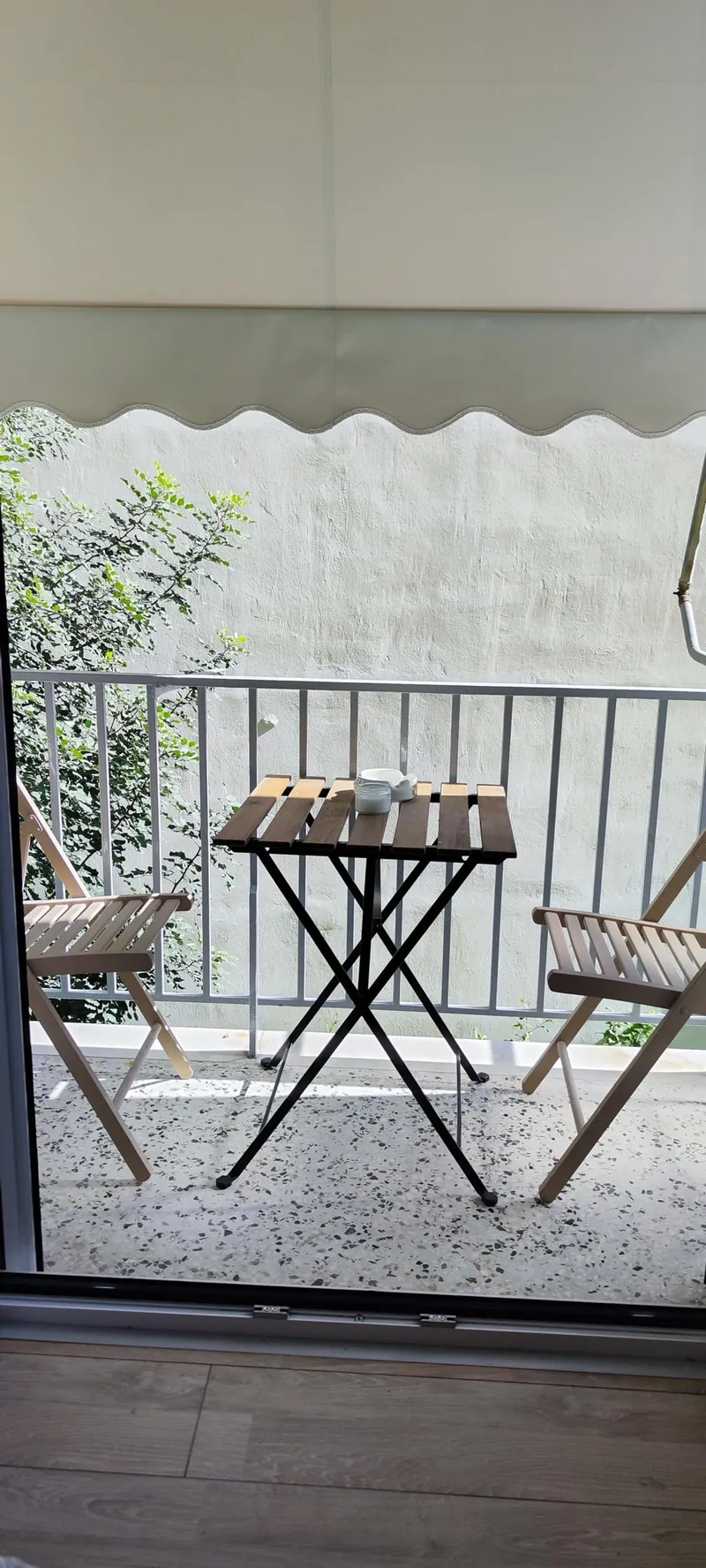 The balcony with a small table and two chairs