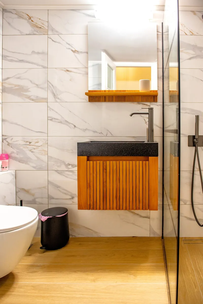 The bathroom with marble tiles