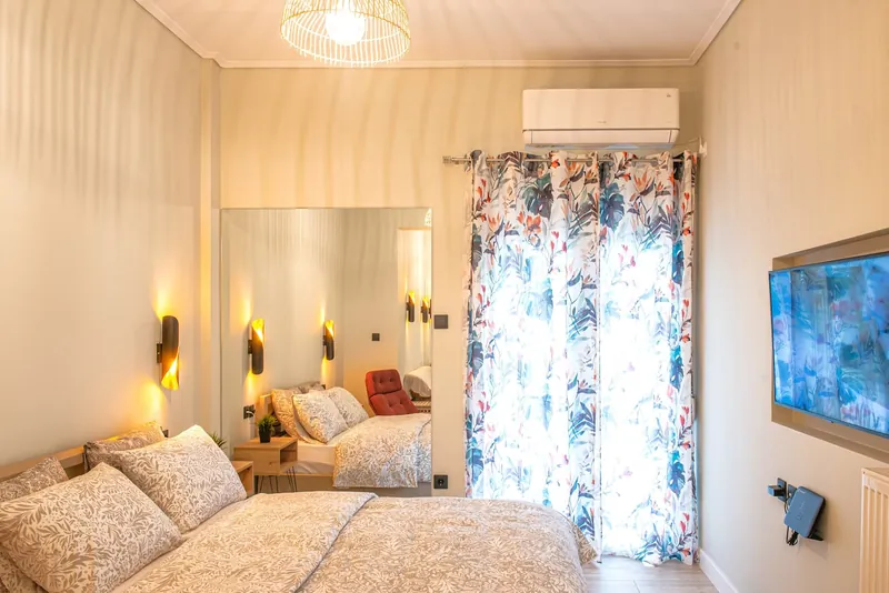 The double bed by the mirror and the balcony door