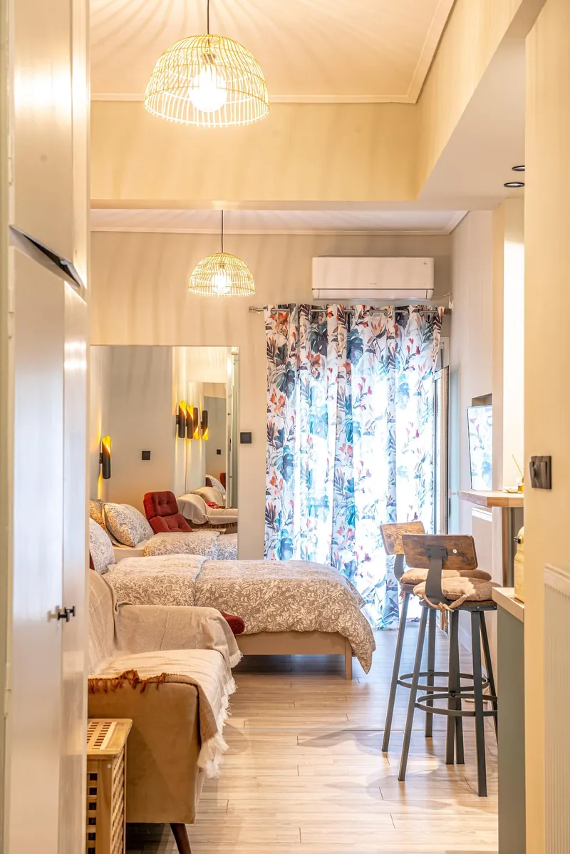 The bed, the balcony door and the kitchen bar