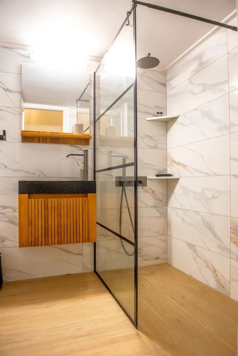 The glass shower and the oak vanity
